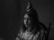 Unhappy young woman wearing party hat