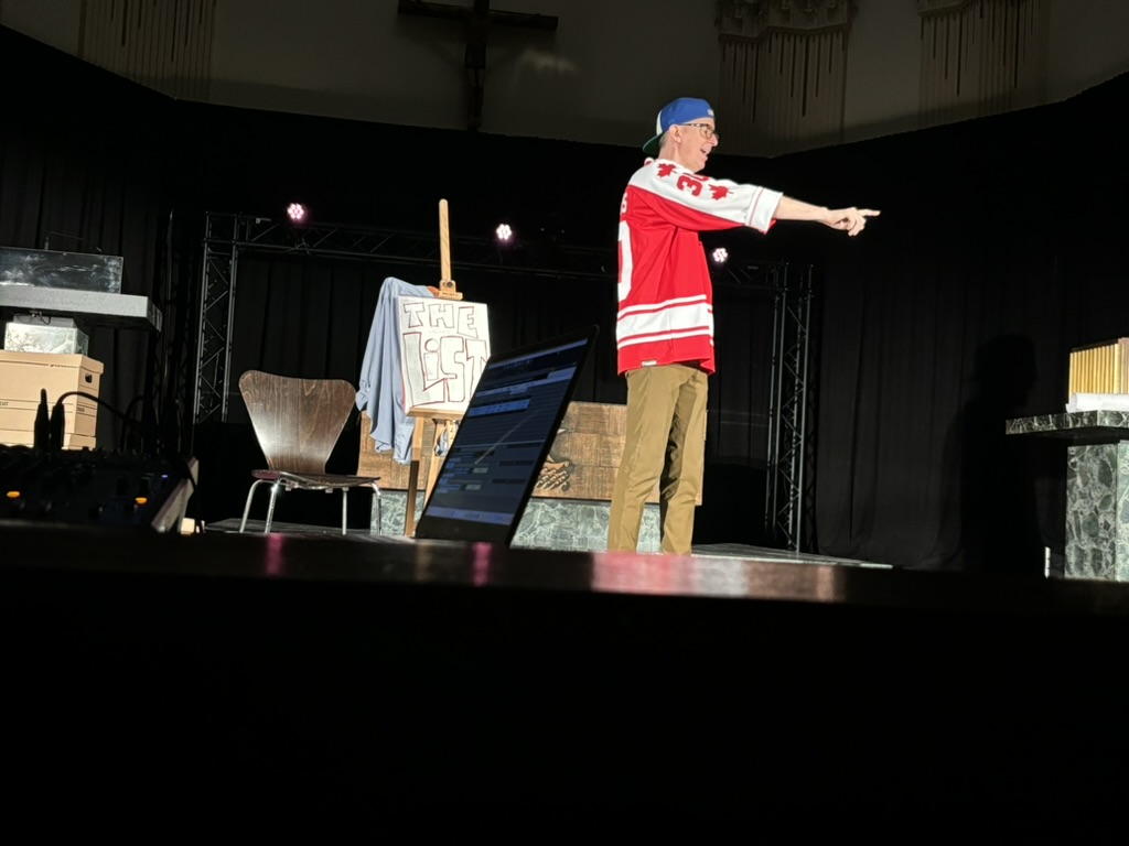 Man wearing habs jersey pointing on stage