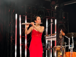 woman in red dress playing flute