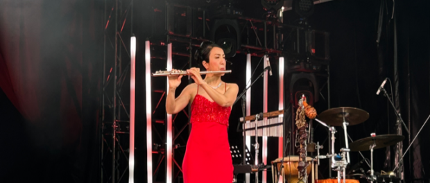 woman in red dress playing flute