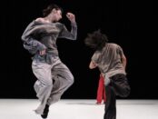 Two dancers in grey outfits