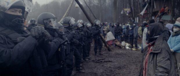 Police face off against activists in foggy bleak area