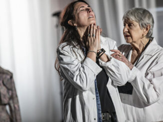 Two women, one middle aged, one older in white coats