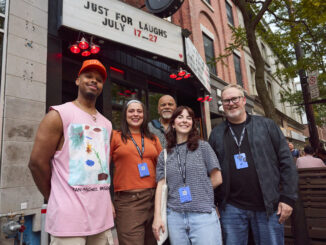 Comedians standing outside venue