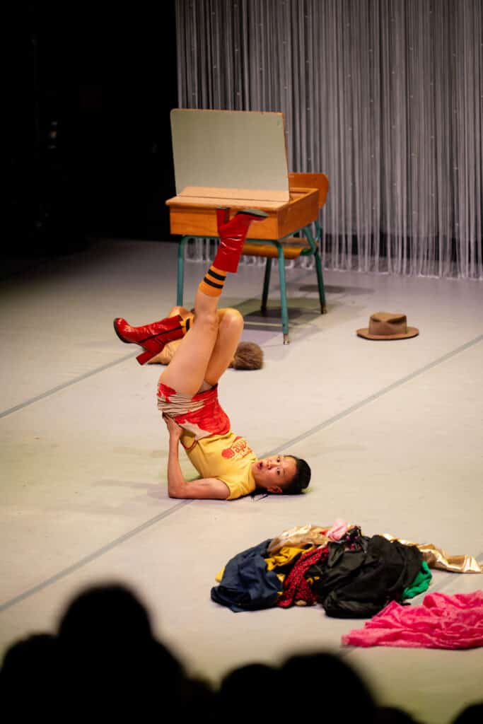 Person doing a performance while wearing red and yellow