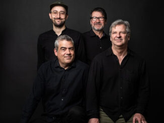 Four musicians in black